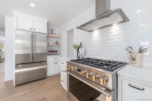 a kitchen with stainless steel appliances granite countertop a stove a refrigerator and a refrigerator