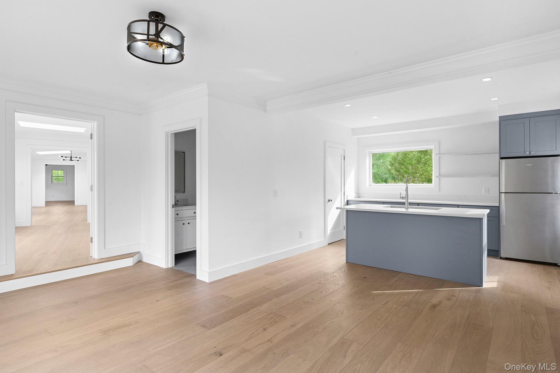 5 Pheasant Lane Remsenburg, NY 11960 - Photo 13 of 27 Unfurnished living room with light wood-style flooring, crown molding, and recessed lighting