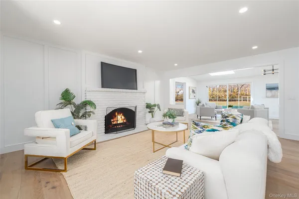 a living room with furniture a fireplace and a table