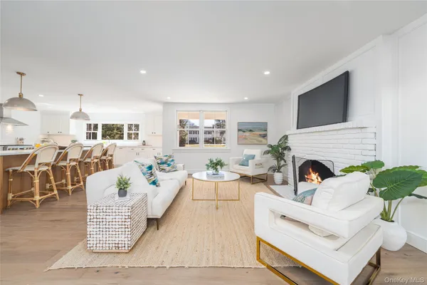 a living room with furniture fireplace and potted plant