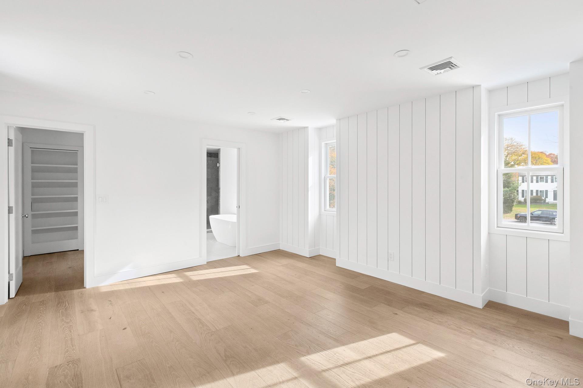 5 Pheasant Lane Remsenburg, NY 11960 - Photo 17 of 27 Unfurnished room featuring light wood-type flooring and baseboards