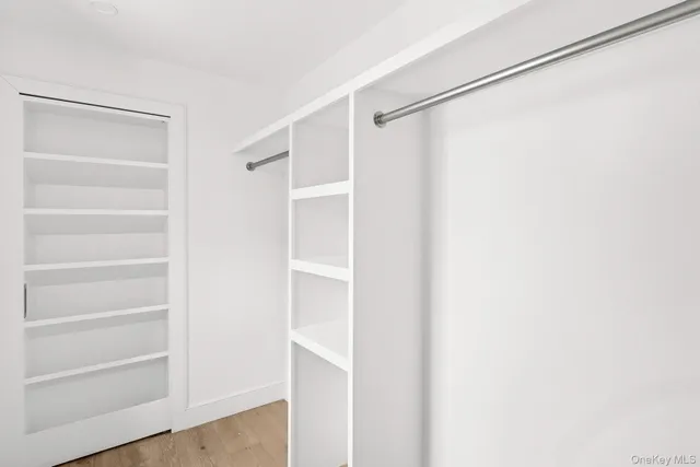 a view of walk in closet with empty racks