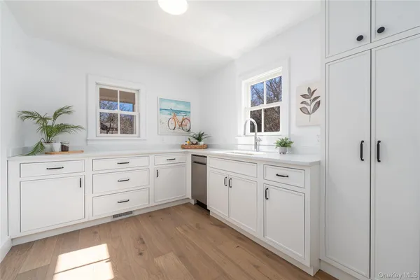 a room with white cabinets and a window