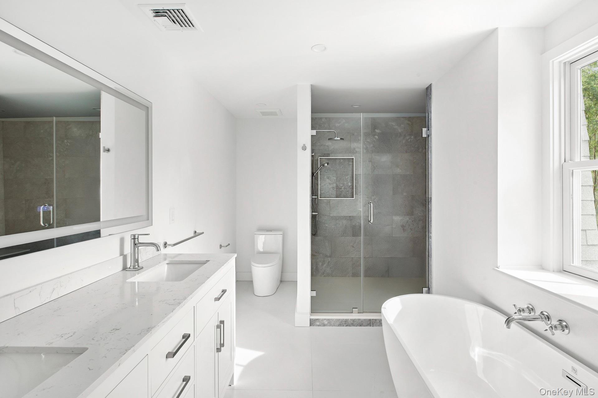 5 Pheasant Lane Remsenburg, NY 11960 - Photo 21 of 32 a bathroom with a granite countertop sink a toilet and shower