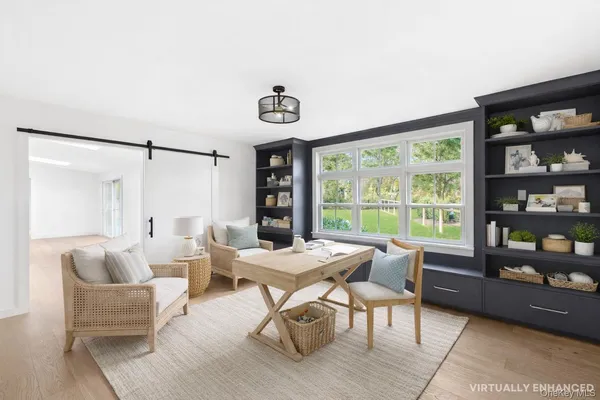 a dining room with furniture and a floor to ceiling window