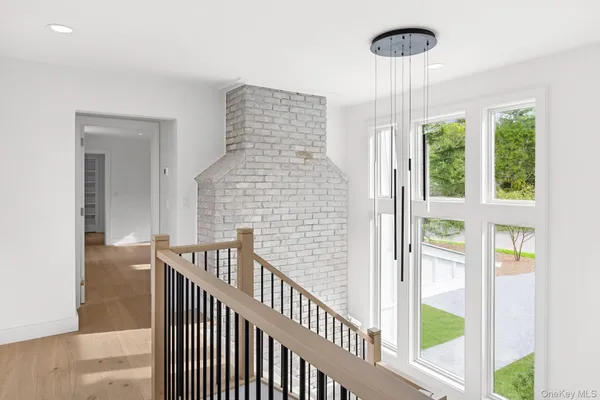 a view of staircase with railing and chandelier