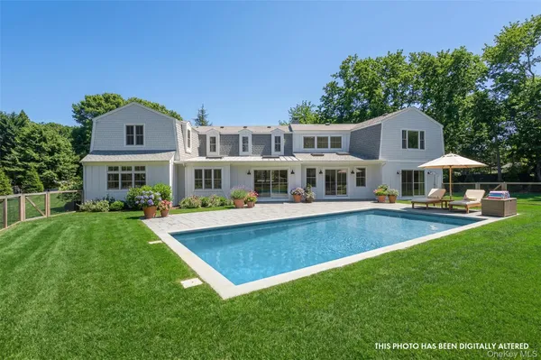a front view of a house with yard and green space