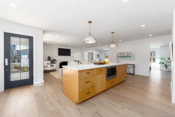a large white kitchen with cabinets a sink and a stove