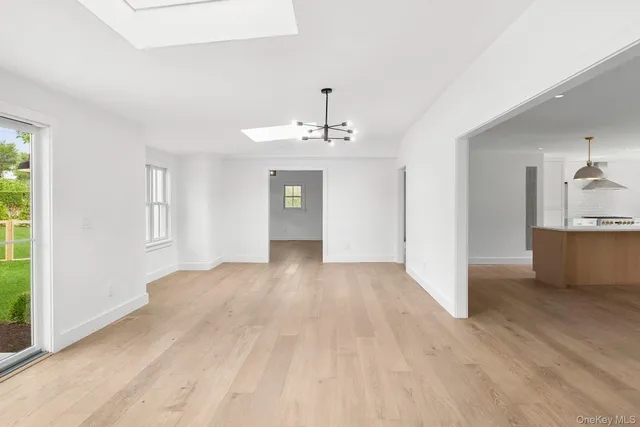 a view of a kitchen with wooden floor and a sink