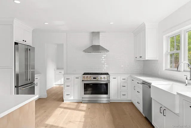 a kitchen with stainless steel appliances a stove sink and refrigerator