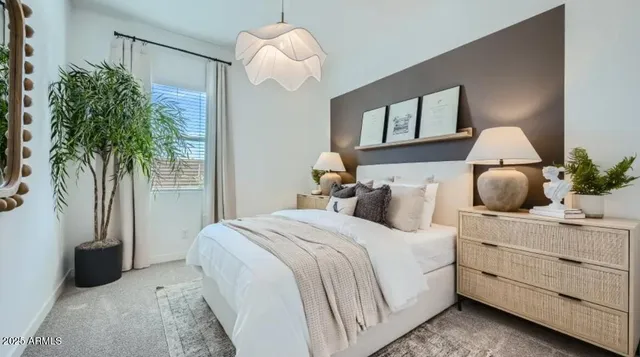 a bedroom with a large bed and a potted plant