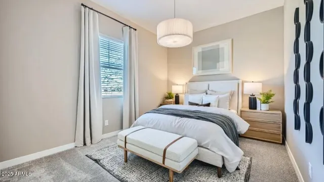 a bedroom with a bed and chandelier