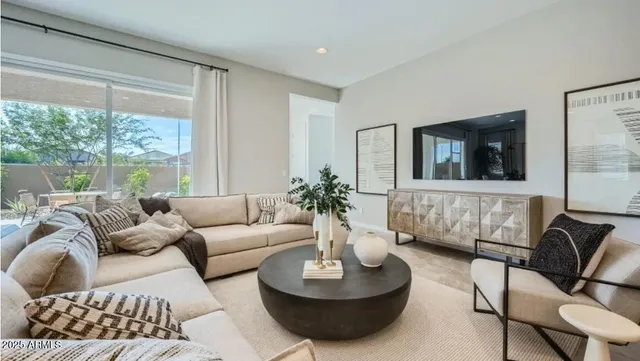 a living room with furniture or couch and a large window