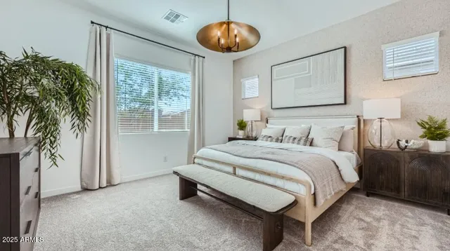 a spacious bedroom with a bed and a large window