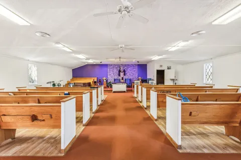 a view of kitchen with cabinets and window