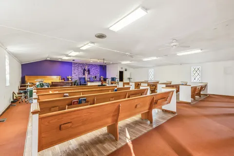a room with gym equipment and view of kitchen