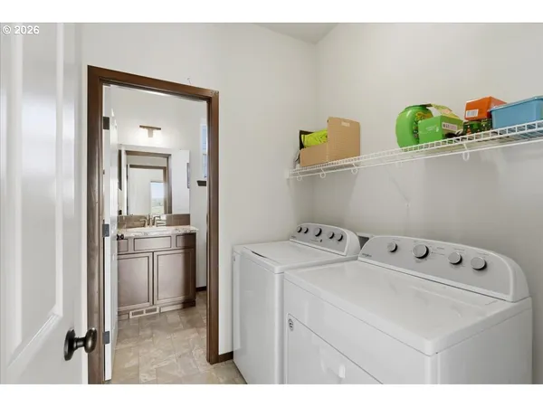 a utility room with dryer washer and sink