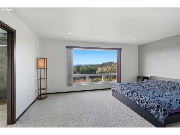 a living room with a bed furniture and next to a window