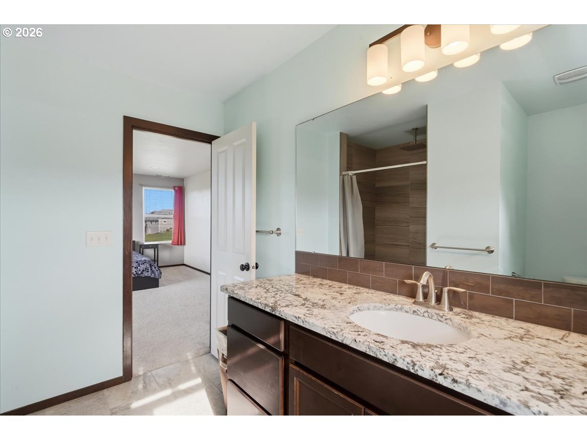 163 Yates Road Chehalis, WA 98532 - Photo 17 of 33 a bathroom with a granite countertop sink and a mirror
