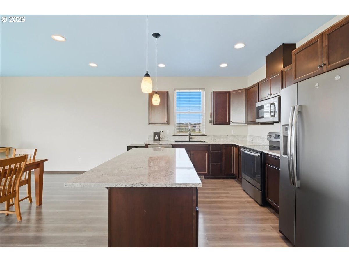 163 Yates Road Chehalis, WA 98532 - Photo 5 of 33 a kitchen with kitchen island stainless steel appliances sink cabinets and stove