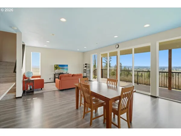 a dining room with furniture window and wooden floor