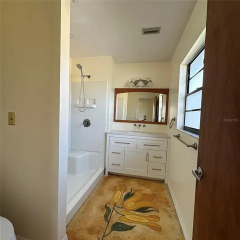 an empty room with windows and closet