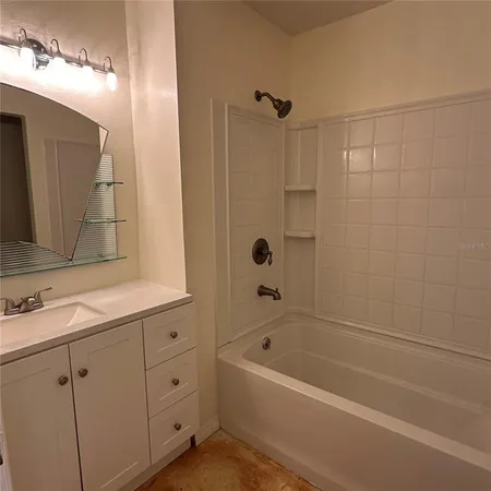 a bathroom with a bathtub a sink a vanity and a shower