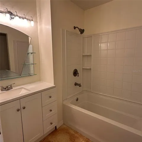 a bathroom with a bathtub a sink a vanity and a shower