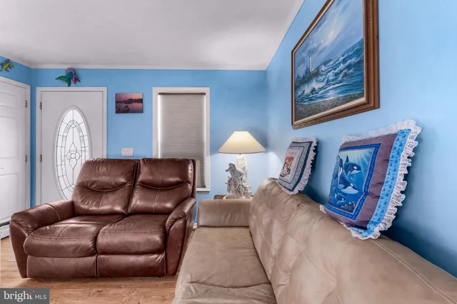 a living room with furniture and a lamp