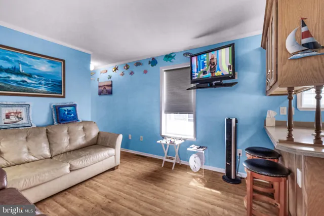 a living room with furniture and a painting on the wall