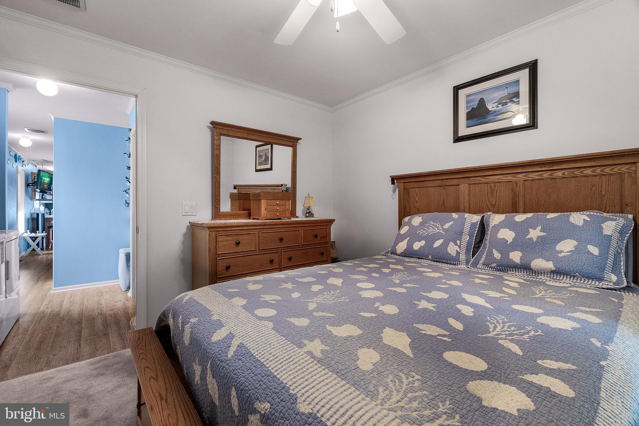 1402 South Rte 9, Unit 25 Cape May Court House, NJ 08210 - Photo 21 of 32 a bedroom with a large bed and a chandelier