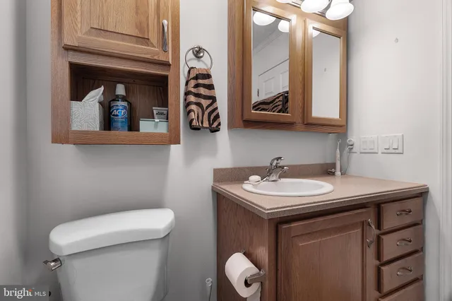 a bathroom with a toilet sink and mirror