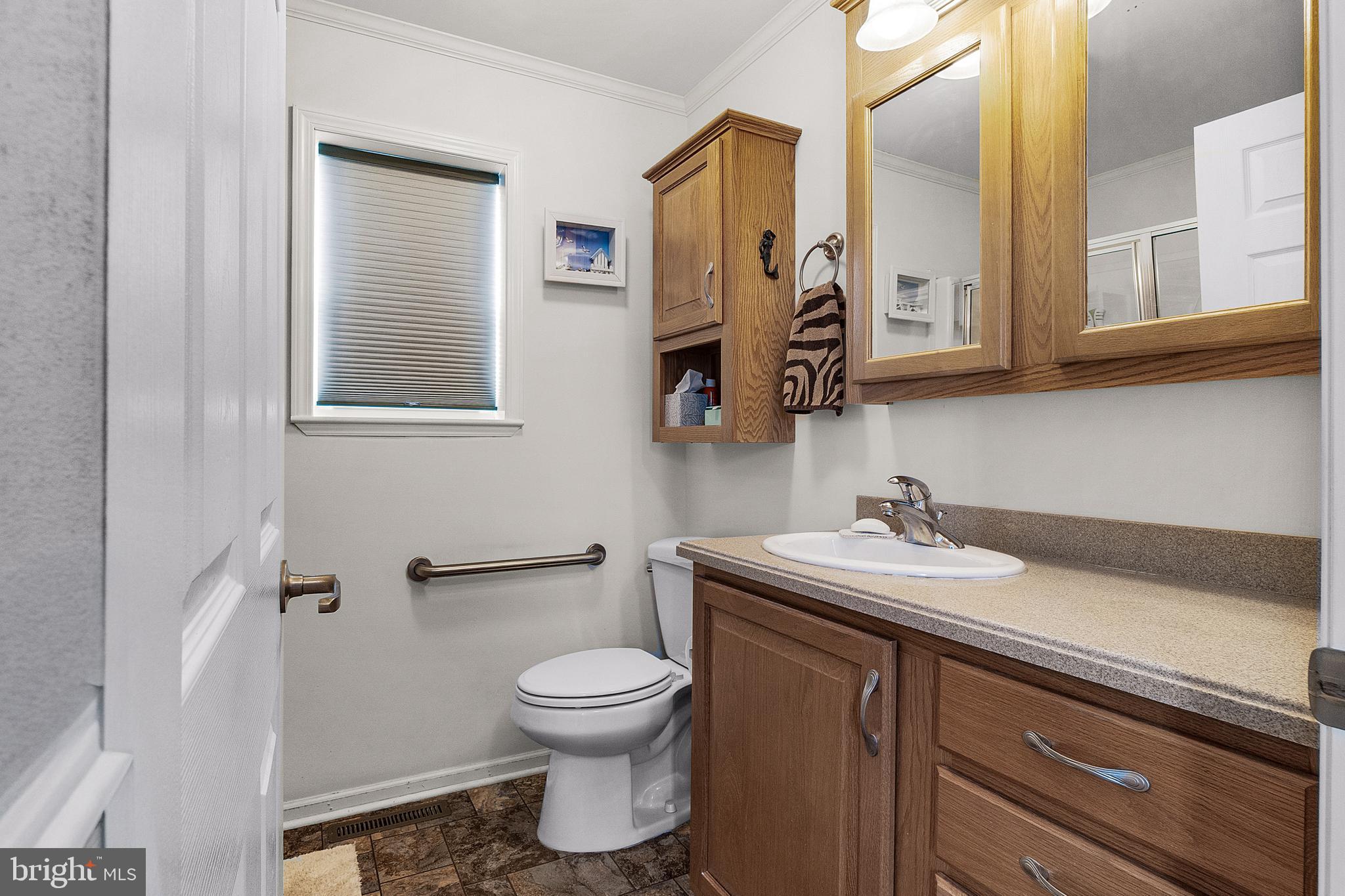 1402 South Rte 9, Unit 25 Cape May Court House, NJ 08210 - Photo 24 of 32 a bathroom with a toilet sink and mirror