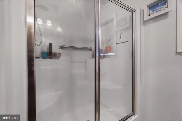 a bathroom with a glass shower door