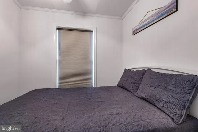 a bedroom with a bed and a mirror