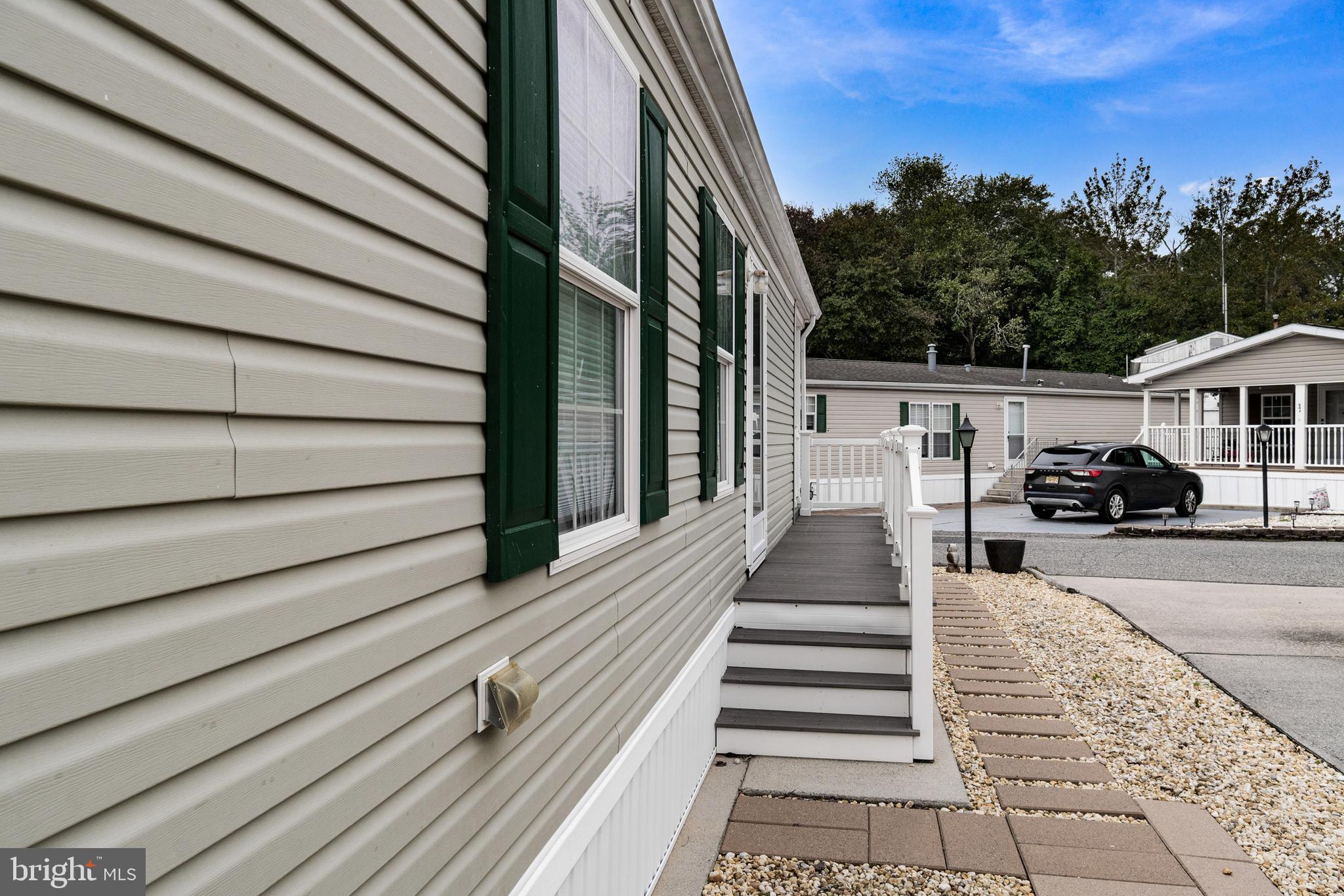 1402 South Rte 9, Unit 25 Cape May Court House, NJ 08210 - Photo 32 of 32 a view of a brick house with a small yard