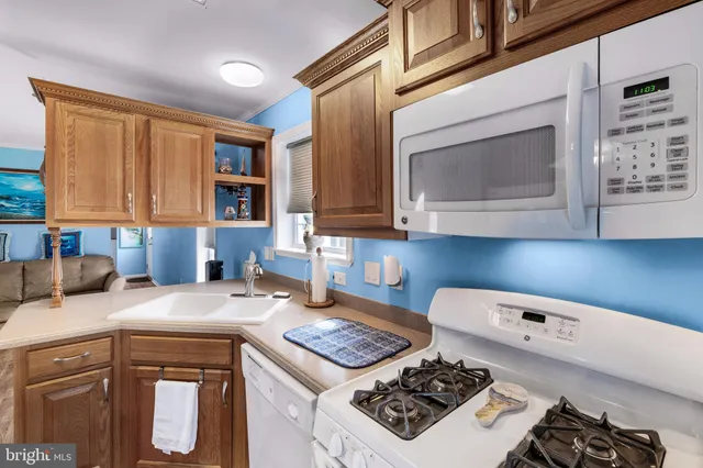 a kitchen with a stove a sink and a microwave