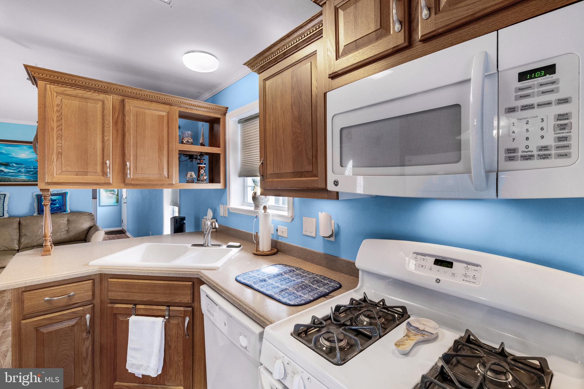 1402 South Rte 9, Unit 25 Cape May Court House, NJ 08210 - Photo 8 of 32 a kitchen with a stove a sink and a microwave