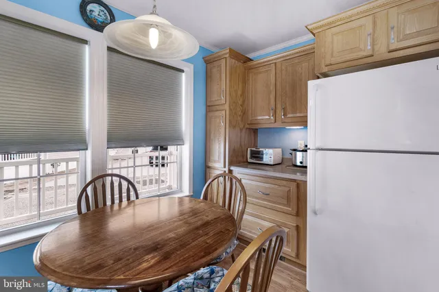 a kitchen with a refrigerator and a table