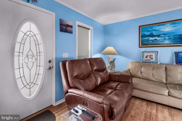 a living room with furniture a table and wooden floor