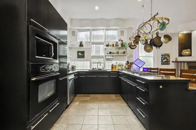 a kitchen with a sink stove and microwave