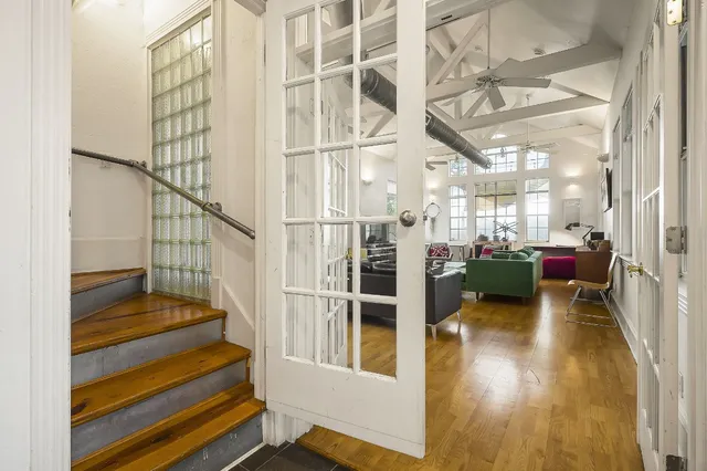 a view of entryway and hall with wooden floor