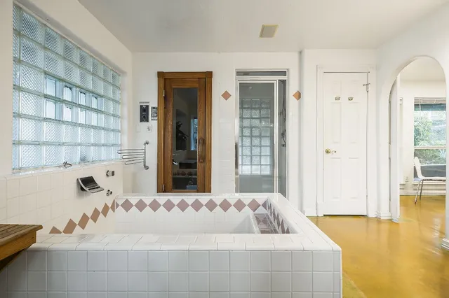 a bathroom with a tub and shower