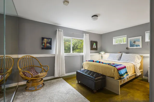 a bedroom with a bed and window