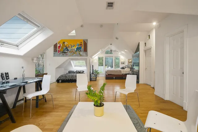 a living room with fireplace furniture and a kitchen view