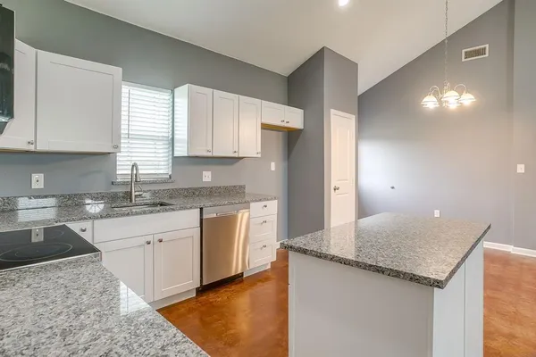 a kitchen with a sink stove and cabinets