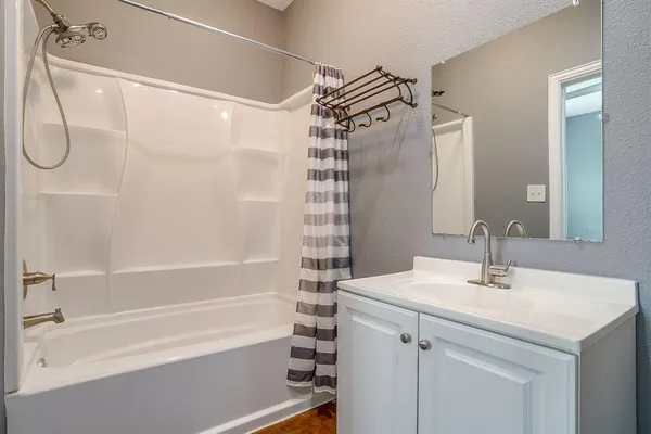 a bathroom with a sink a mirror and a shower