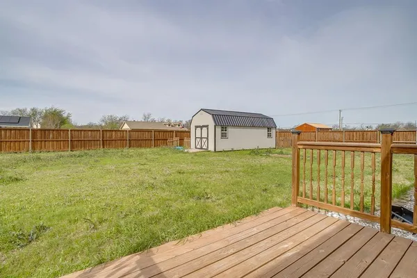 a view of a terrace with wooden floor and fence