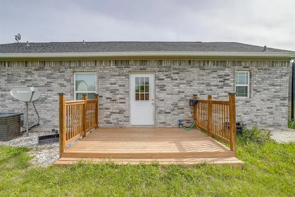 a balcony with a floor to ceiling window next to a yard