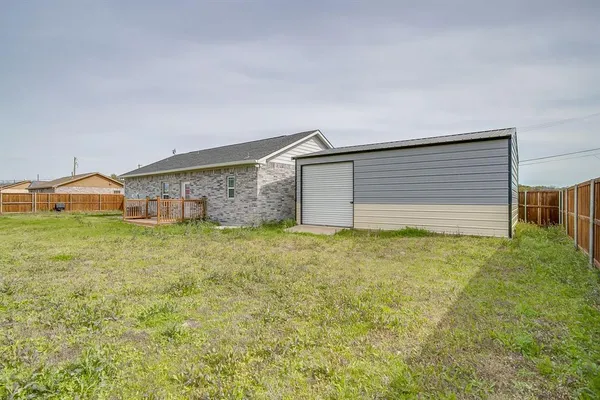 a view of a house with a backyard
